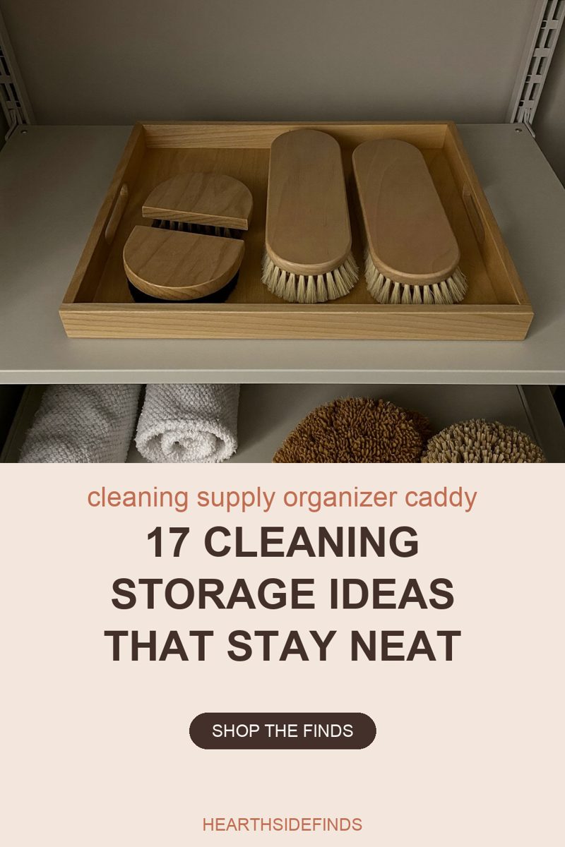 Photo of a shallow open-topped wooden tray on a pale grey shelf holding four wooden scrubbing brushes lying bristles-down — two long pale-wood brushes with cream bristles side by side on the right and two round brushes with dark bristles stacked on the left — with the shelf below showing two rolled white cloths and two round scrubbers, one shaggy brown and one stiff pale bristle, all cut off by the bottom edge of the frame